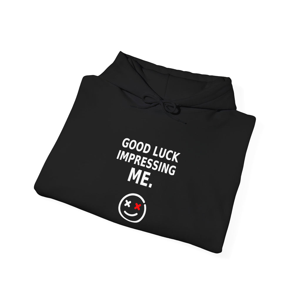 Folded detail view of the Good Luck Impressing Me black statement hoodie